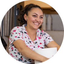 a female housekeeper smiling at camera
